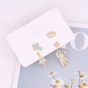 Detailed view of S925 silver stud earrings set featuring evil eye and cross motifs
