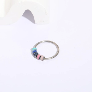 Detail of adjustable silver ring featuring five multi-colored spinning enamel beads
