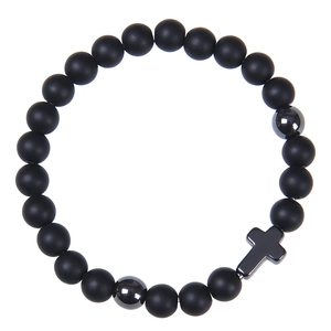 Detail of 8mm matte black stone beads bracelet with a metallic cross charm and accents