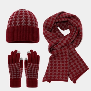 Detail of burgundy diamond-pattern knit set including scarf, beanie, and touch gloves