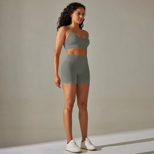 Detail view of ribbed gray-green seamless yoga set showing V-neck top and high waist shorts