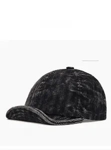 Detail of black corduroy baseball cap showing soft washed texture and vintage stitching