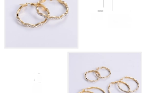 Close-up of gold plated wavy hoop earrings with micro pavé cubic zirconia inlay