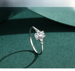Macro shot of S925 sterling silver ring featuring emerald-cut center stone and side diamonds