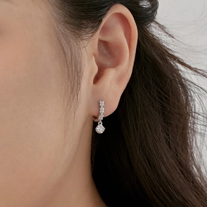 Macro view of S925 sterling silver earring with geometric cubic zirconia pendant on ear