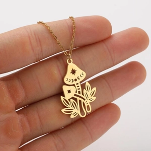 Detail of gold mushroom necklace with celestial star and moon patterns on pendants