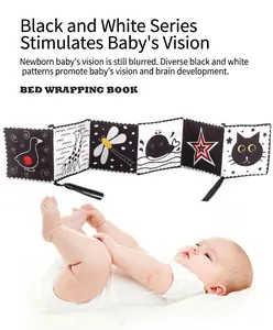 Close-up of double-sided high contrast black and white baby cloth book with animal patterns