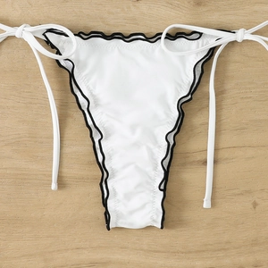 Detail of white bikini bottoms with black scalloped edges and adjustable side ties