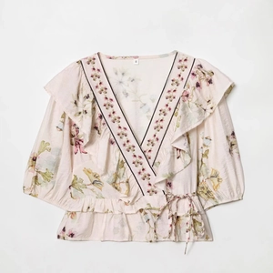 Floral V-neck linen blend top with ruffled sleeves and belted waist on white background