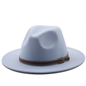 Detail of wool fedora hat featuring a brown leather decorative band and vintage metal buckle