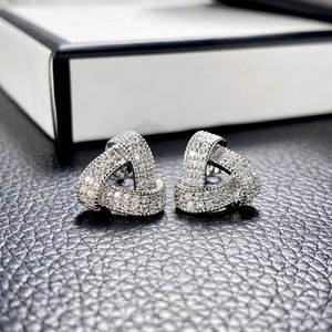 Macro shot of geometric triangle stud earrings with shimmering micro-pave cubic zirconia