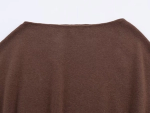 Detailed view of the fine knit texture and flat neckline on this dark brown top