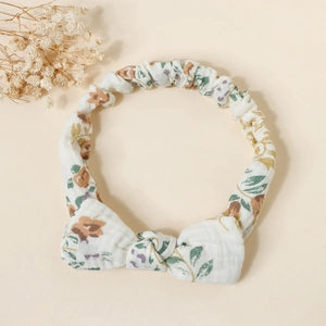 Detail view of cotton floral headband showing bow knot and elastic band texture