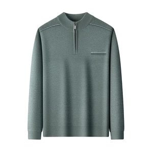 Macro detail of the dark grey-green knit sweater featuring a semi-zipper collar design