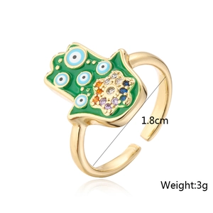 Detail of gold-plated Hamsa ring featuring green enamel and 1.8cm inner diameter