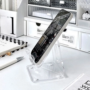 Macro detail of clear acrylic phone stand with minimalist thickened desktop design