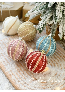 Close-up of glitter Christmas balls with pearl strings and hemp rope details