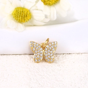 Detailed view of a gold-plated butterfly pendant set with sparkling cubic zirconia crystals