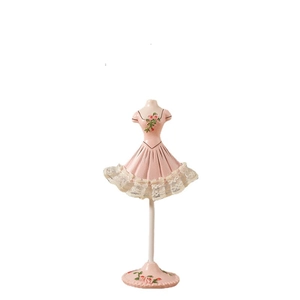 Pink ballerina dress jewelry display stand with lace and flower detail on white background