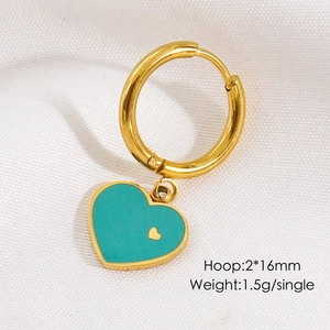 Macro shot of gold hoop earring with Tiffany blue enamel heart charm and micro heart detail