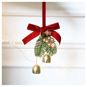 Close-up of Christmas wreath ornament with red velvet bow, gold bells, and pine cones