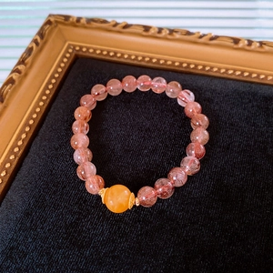 Macro detail of strawberry quartz beads and lotus agate on a luxury beaded bracelet