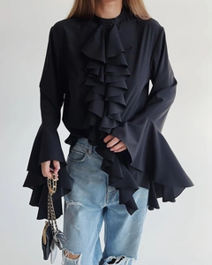 Detail of ruffled front and flared sleeves on a black chiffon French style shirt