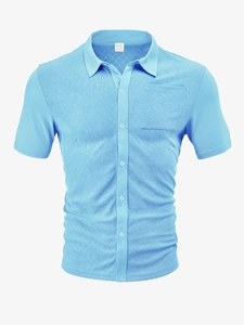 Close-up of sky blue waffle knit texture and button collar on men's polo shirt