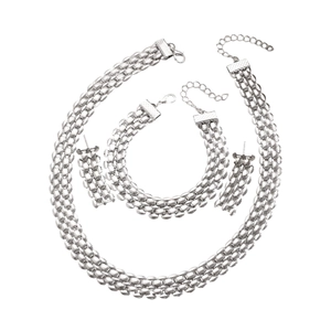 Detail of silver mesh chain jewelry set with necklace bracelet and earrings on white background