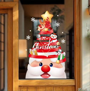 Detail of Christmas window stickers featuring Santa, stars and gift boxes on a glass door