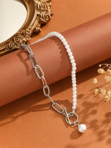 Detail of a pearl and silver chain necklace with an OT toggle clasp and pearl pendant