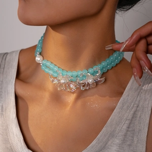 Detail of double-layer choker with light blue beads and pearlescent floral accents