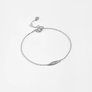 Macro detail of 925 sterling silver bracelet with oval zircon charm and spring clasp