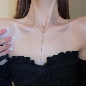 Close-up of double-layer stainless steel star pendant necklace with cubic zirconia details