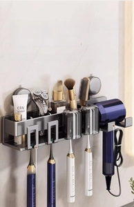 Detail of grey aluminum bathroom shelf with hair dryer holder and toothbrush slots
