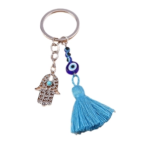 Silver metal Evil Eye keychain with blue beads and a decorative blue fringe tassel