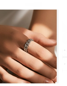 Macro shot of s925 silver punk chain ring with pavé diamonds on woman's hand