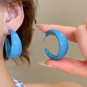 Vibrant blue acrylic C-shaped hoop earrings with glossy finish and minimalist design