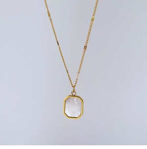 Macro shot of 18K gold plated octagonal pendant featuring natural white shell inlay
