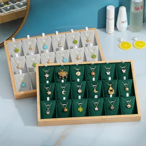 Bamboo jewelry display tray with 18 compartments for necklaces and gold pendants
