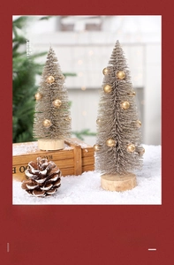 Mini pine needle Christmas trees with gold glitter and wooden base on snow
