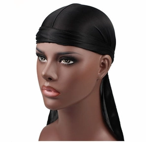 Detail view of the black silk-like durag fabric texture on a mannequin with white background