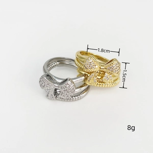Detail view of gold and silver butterfly rings showing dimensions 1.8cm by 1.5cm and 8g weight