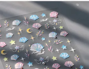 Close-up of 3D shell and starfish nail stickers with holographic pearl details