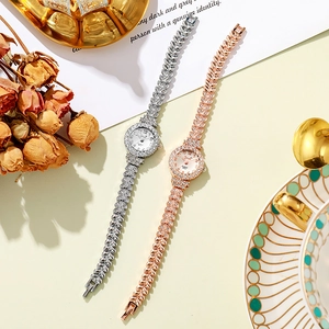 Close-up of elegant women's quartz watches with sparkling heart-shaped metal link bands