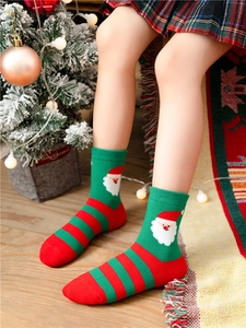 Cartoon Santa Claus Christmas cotton socks for kids worn in a cozy holiday setting