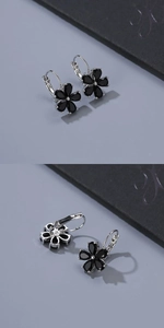 Detailed close-up of flower shaped leverback earrings with five black teardrop stones