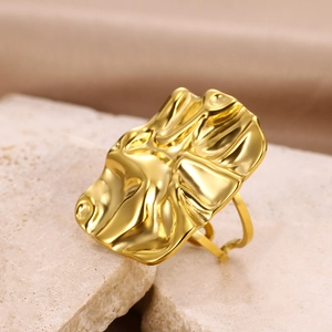 Macro shot of irregular textured gold-plated ring with liquid metal lava aesthetic detail