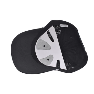 Detail view of the breathable mesh back and 100% polyester fabric label inside the black cap