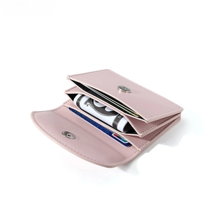 Detail view of pinkish-purple faux leather wallet with multi-card slots and magnetic closure